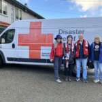 American Red Cross volunteers in front of a van.