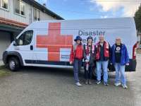 American Red Cross volunteers in front of a van.