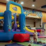 2ab00748-586d-499f-b102-35c02daee1b4 Kids play in an inflatable house inside Marie Drake.