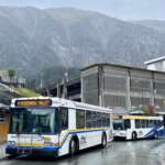 Two buses at bus depot.